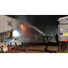 Veel schade door brand in bedrijfspand aan De Corantijn in Zwaag